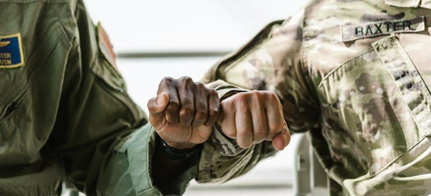 a close-up of two soldiers doing a fist bump