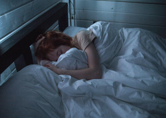 A person hugging their pillow.